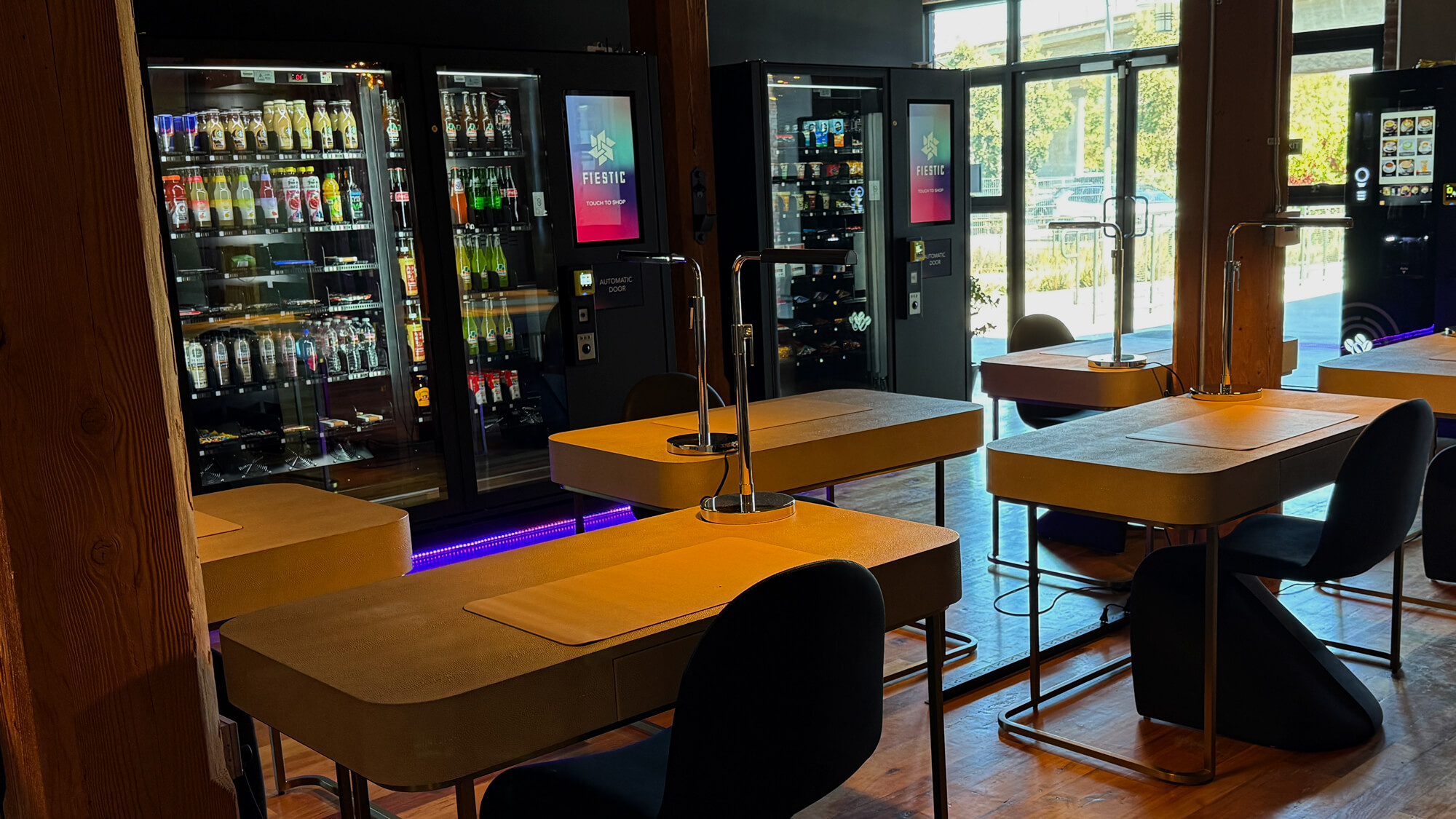 Interior view of Fiestic office showing a row of desks in front of high-tech vending machines.