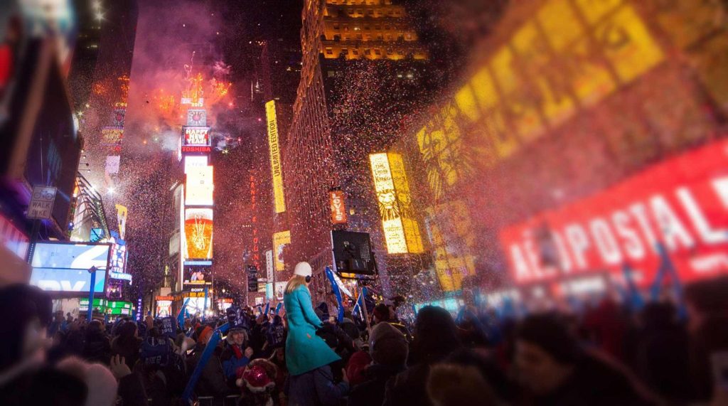 New Yorkers welcome the New Year in Time Square with fireworks, confetti, and a street party.