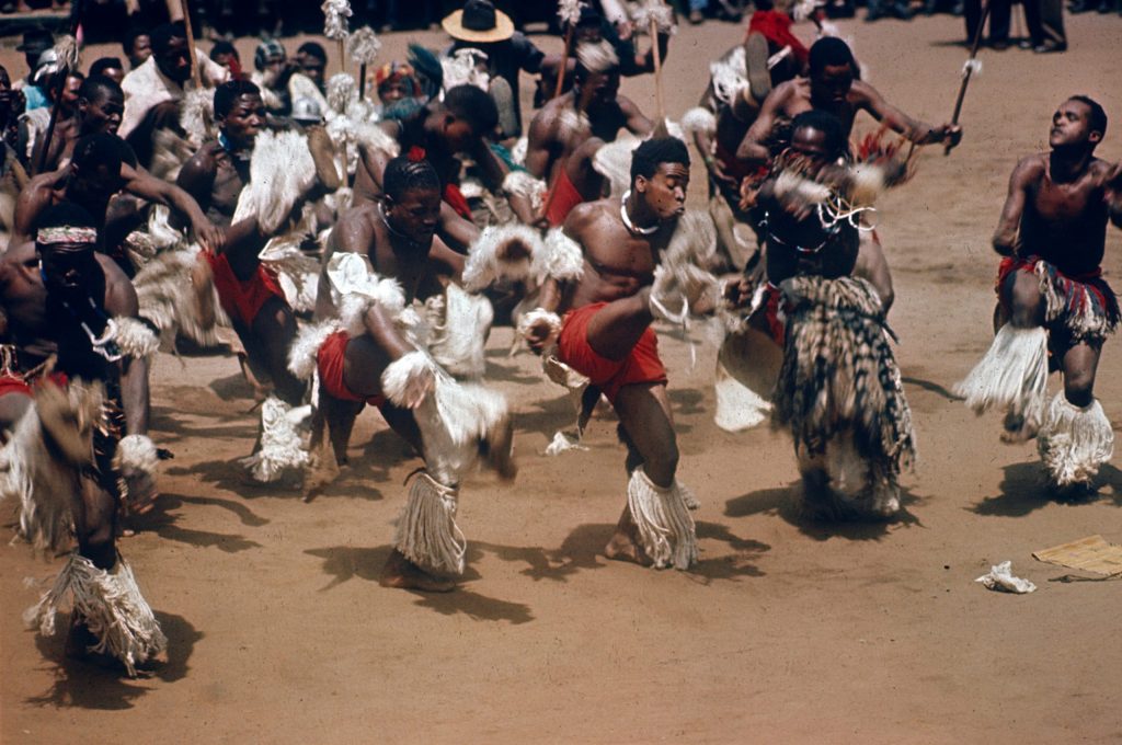South Africa, 1969. Young Zulu men performing a traditional group dance.