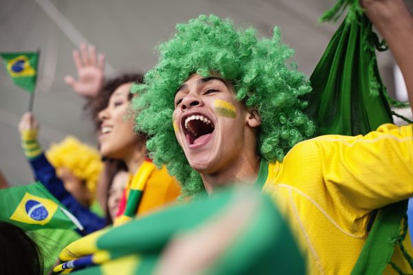 Ecstatic brazilian fan watching a football game, World Cup