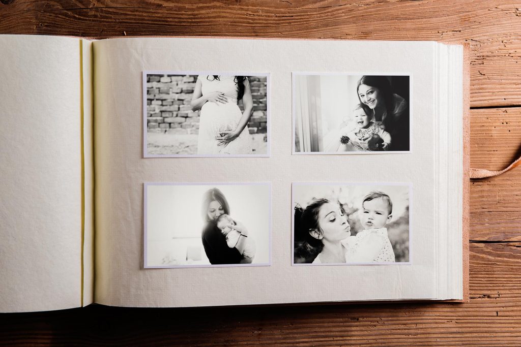 Overhead view of a Mother's Day scrap book with four photos of moms and babies
